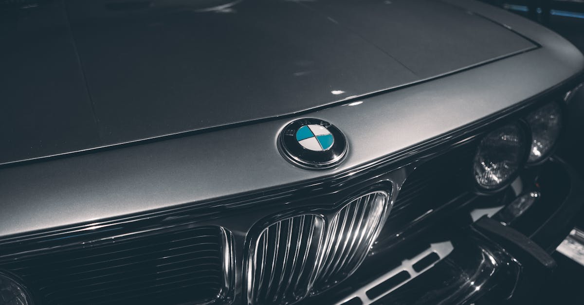 Close-up of classic BMW hood showcasing emblem and chrome details. Captured in Munich, Germany.